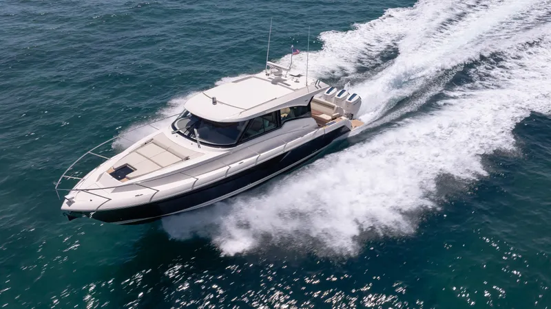  Yacht Photos Pics 2024 Tiara Yachts 48 LE cruising on open water, showcasing sleek design and powerful performance.