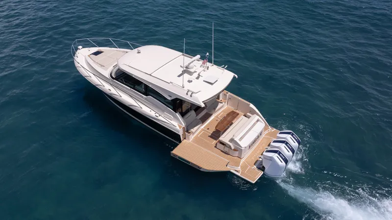  Yacht Photos Pics 2024 Tiara Yachts 48 LE cruising on open water, showcasing sleek design and powerful engines.