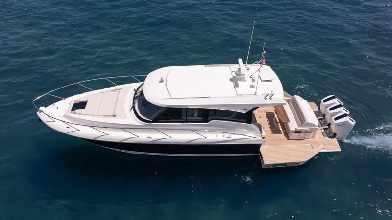  Yacht Photos Pics 2024 Tiara Yachts 48 LE cruising on open water, showcasing sleek design and powerful engines.