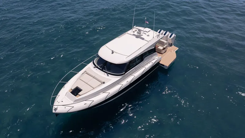  Yacht Photos Pics 2024 Tiara Yachts 48 LE cruising on open water, showcasing sleek design and luxury features.