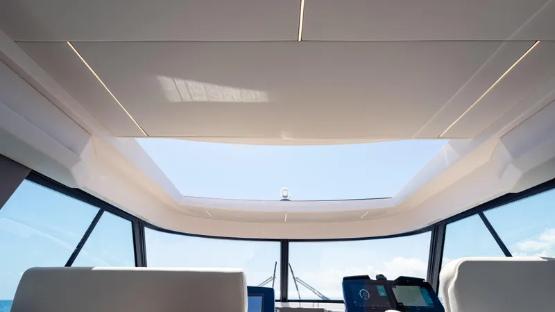  Yacht Photos Pics 2024 Tiara Yachts 48 LE interior with panoramic sunroof and modern dashboard.