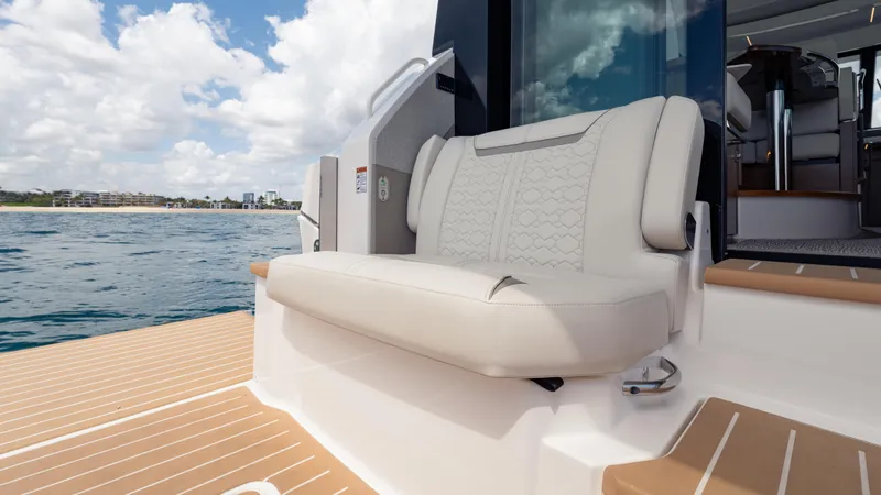  Yacht Photos Pics 2024 Tiara Yachts 48 LE with elegant seating, docked on calm waters under a cloudy sky.