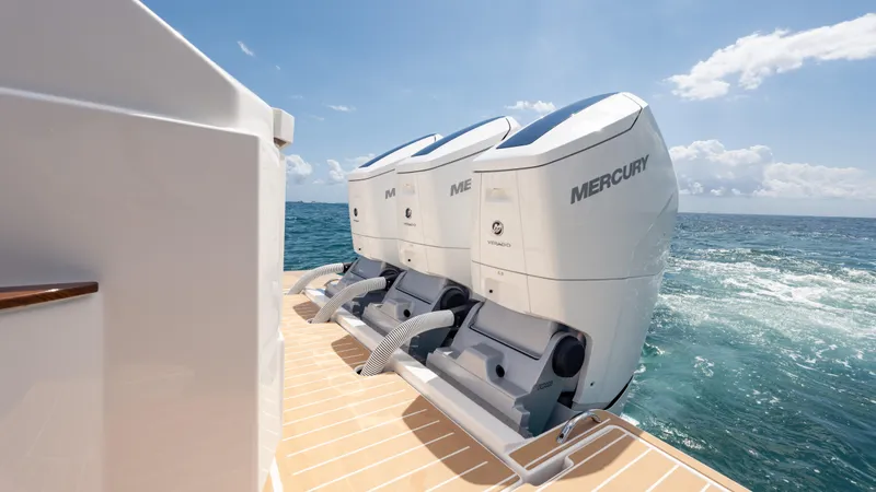  Yacht Photos Pics 2024 Tiara Yachts 48 LE with dual Mercury outboard engines on open sea.