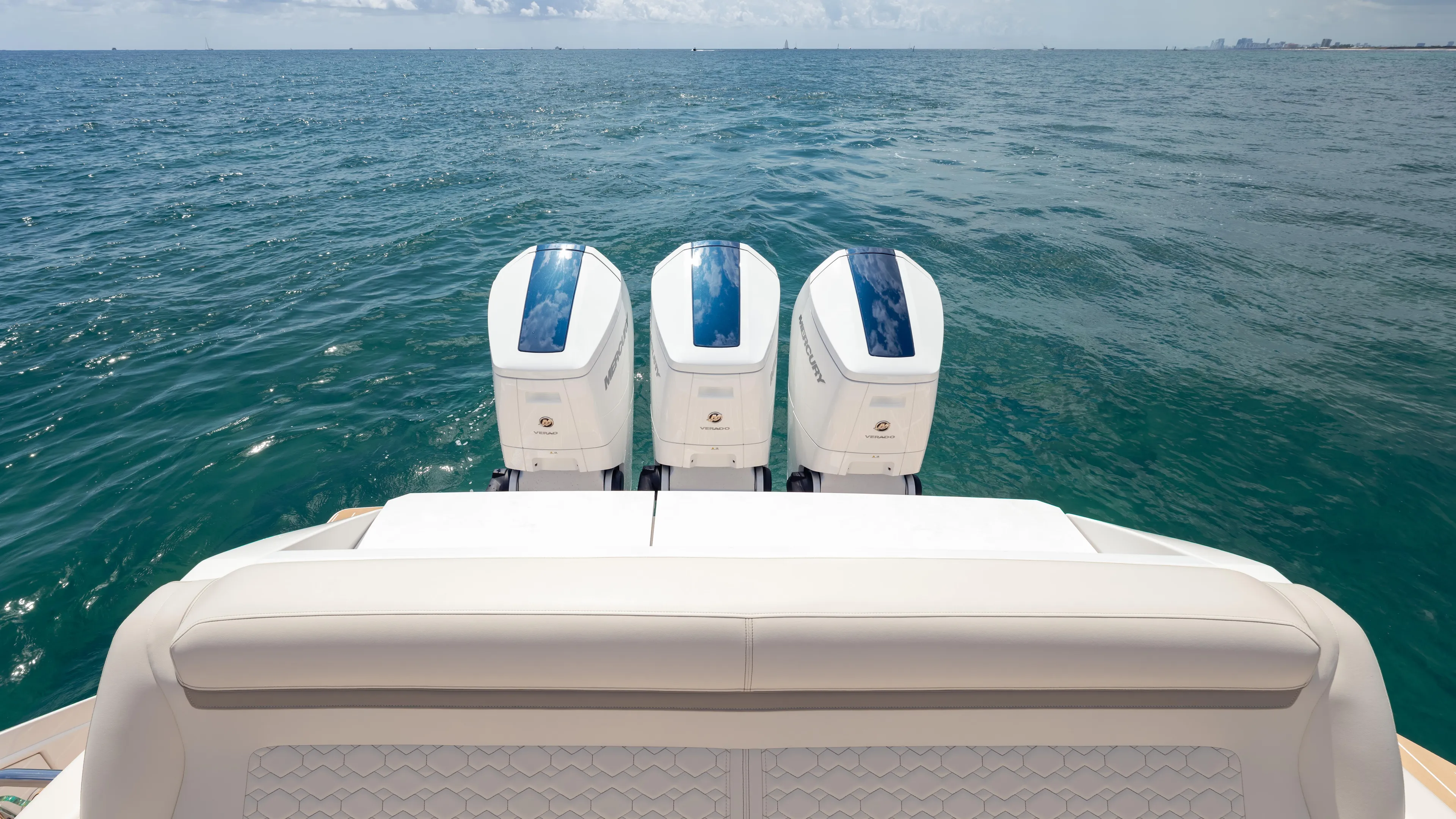  Yacht Photos Pics 2024 Tiara Yachts 48 LE with triple outboard engines on open sea.