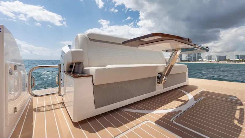  Yacht Photos Pics 2024 Tiara Yachts 48 LE luxury yacht deck with seating, ocean view, and city skyline.