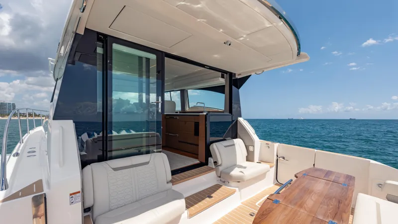  Yacht Photos Pics 2024 Tiara Yachts 48 LE luxury yacht interior with ocean view, featuring elegant seating and table.