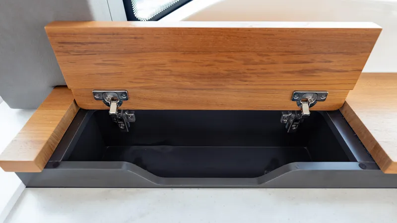  Yacht Photos Pics Open wooden storage compartment on 2024 Tiara Yachts 48 LE.