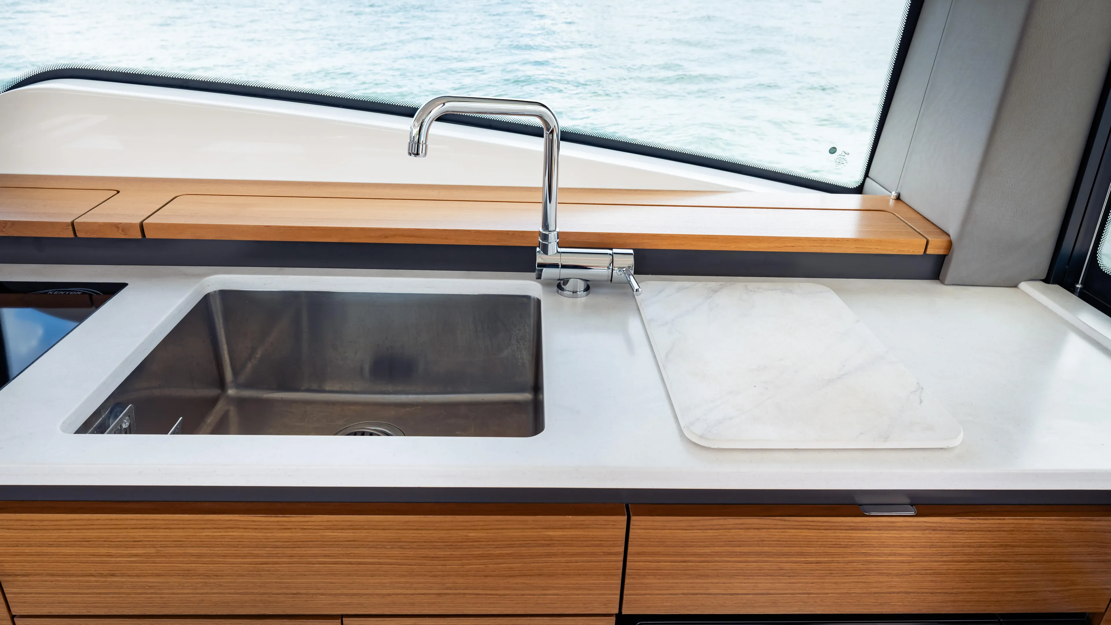  Yacht Photos Pics 2024 Tiara Yachts 48 LE kitchen sink with modern faucet and wooden cabinetry.