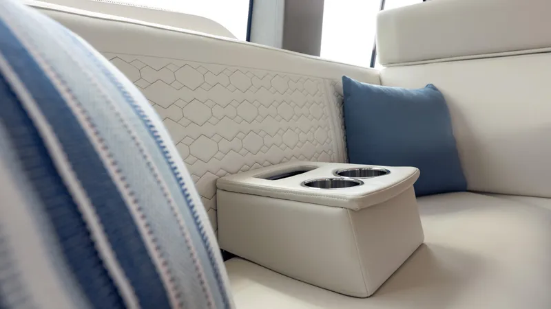  Yacht Photos Pics Luxurious seating with cup holders on 2024 Tiara Yachts 48 LE, featuring elegant cushions.