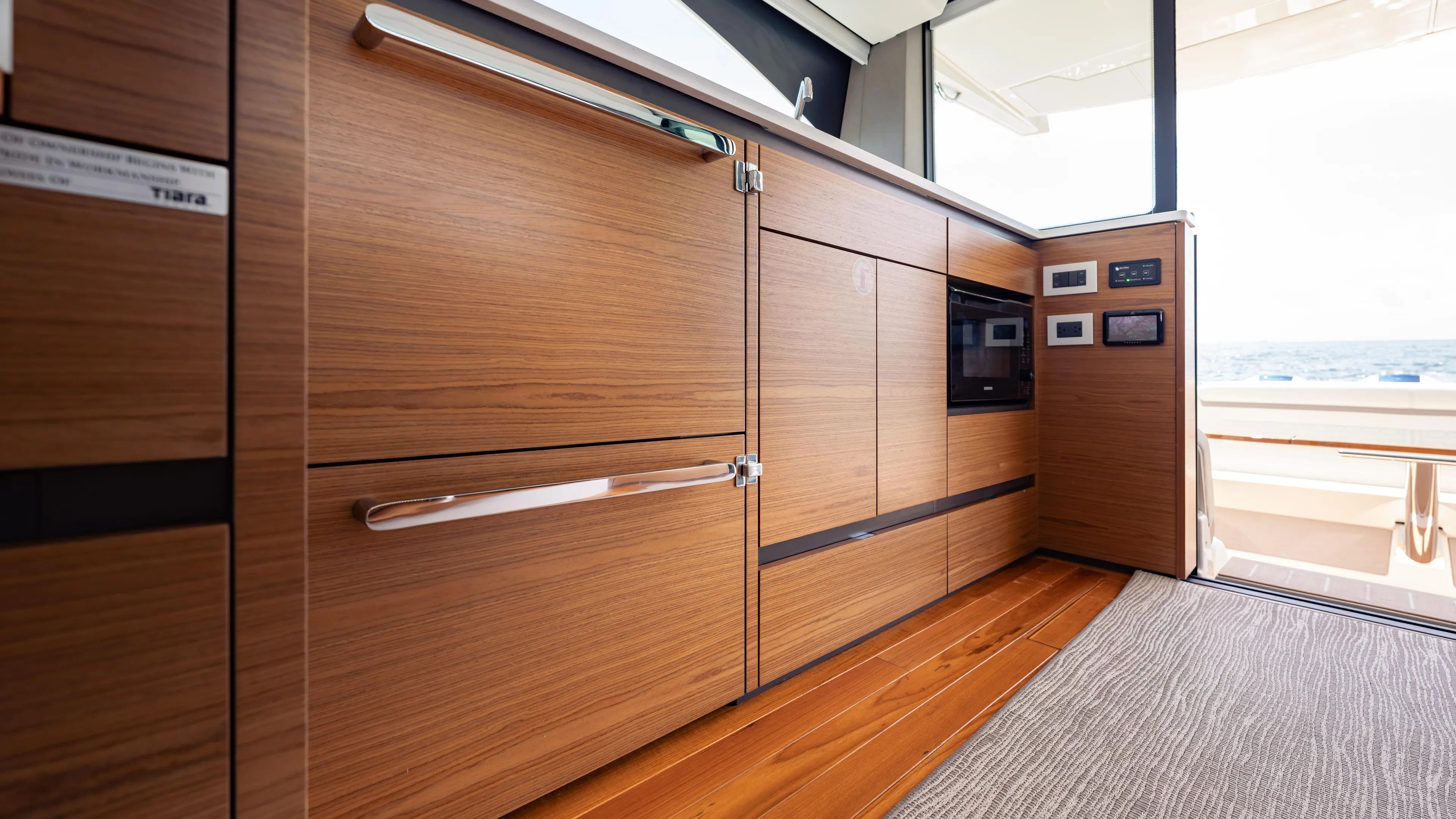  Yacht Photos Pics 2024 Tiara Yachts 48 LE interior with sleek wooden cabinetry and modern appliances.