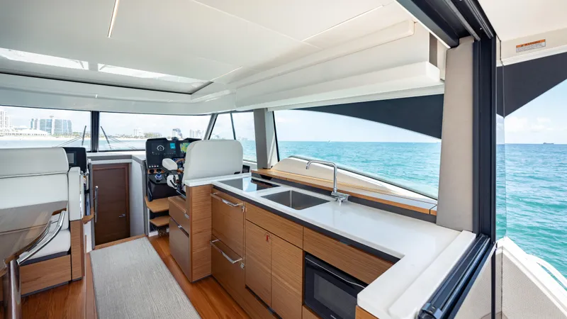  Yacht Photos Pics 2024 Tiara Yachts 48 LE interior with modern kitchen and ocean view.