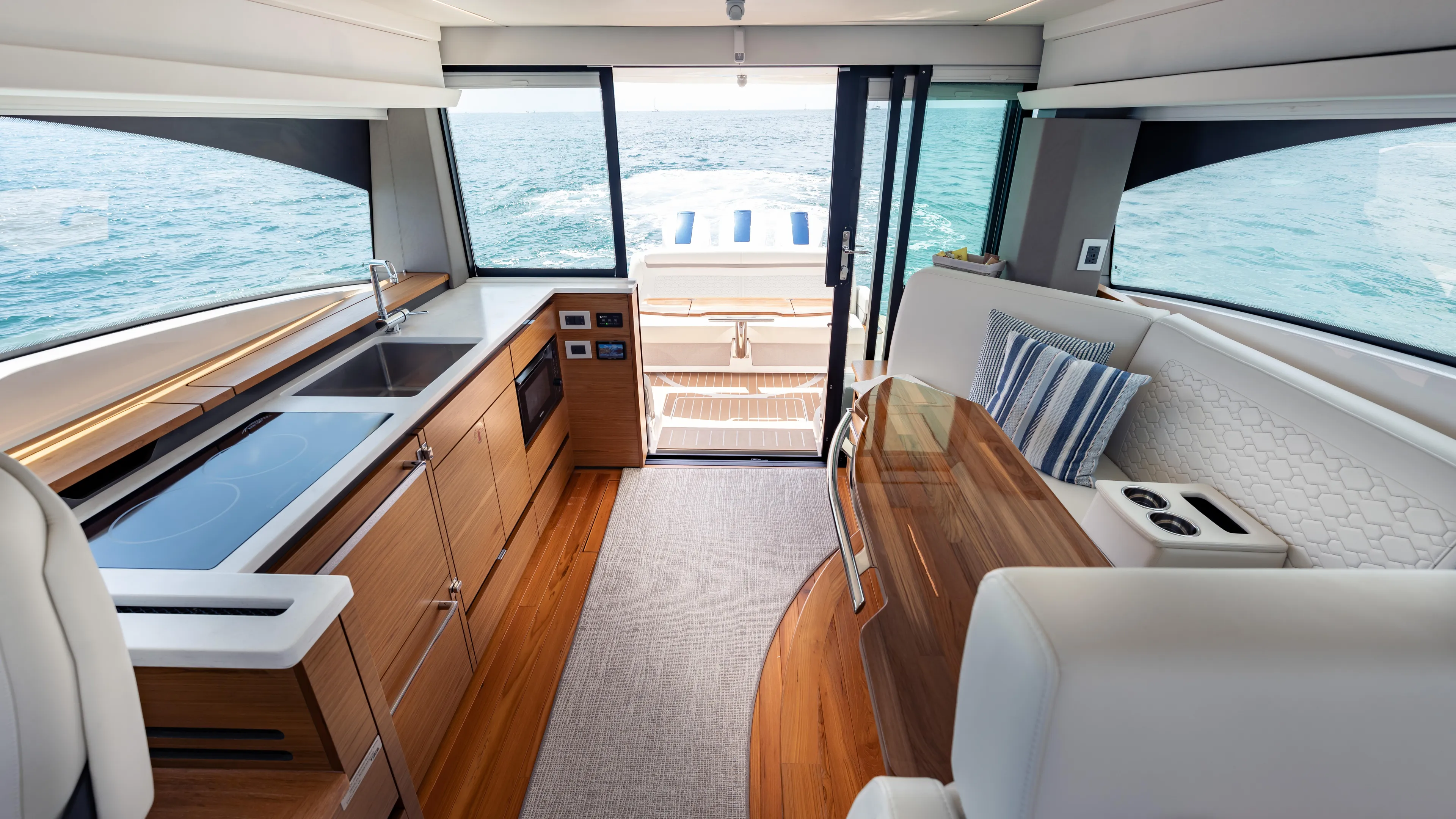  Yacht Photos Pics Luxurious interior of 2024 Tiara Yachts 48 LE with modern kitchen and seating area.