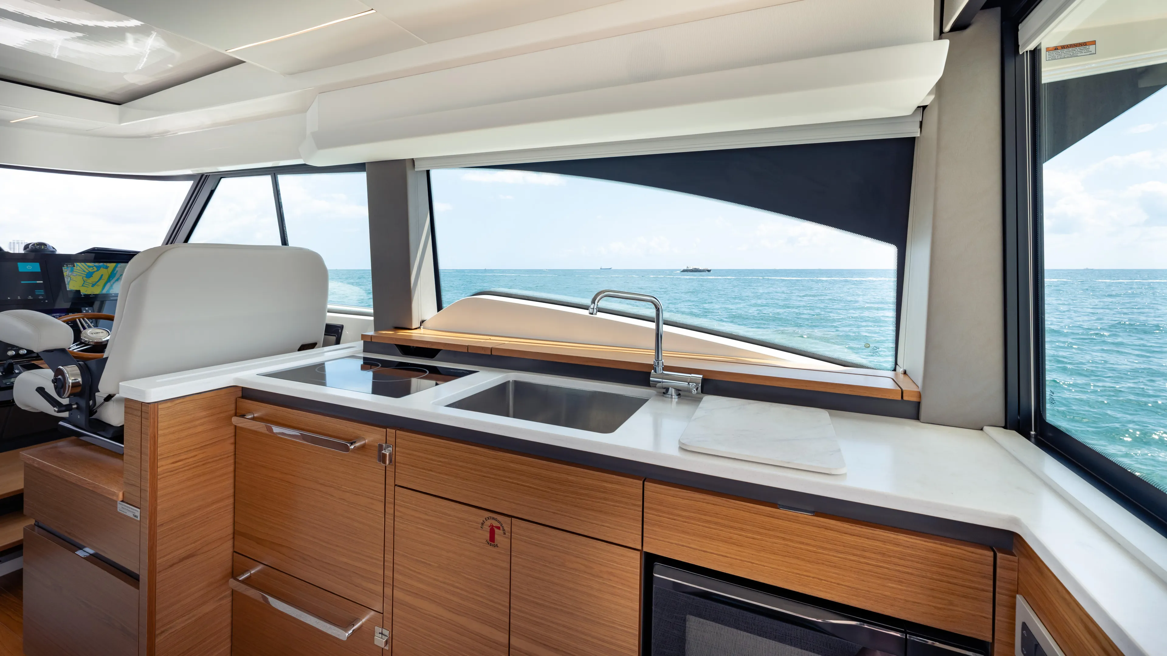  Yacht Photos Pics 2024 Tiara Yachts 48 LE interior with modern kitchen and ocean view.