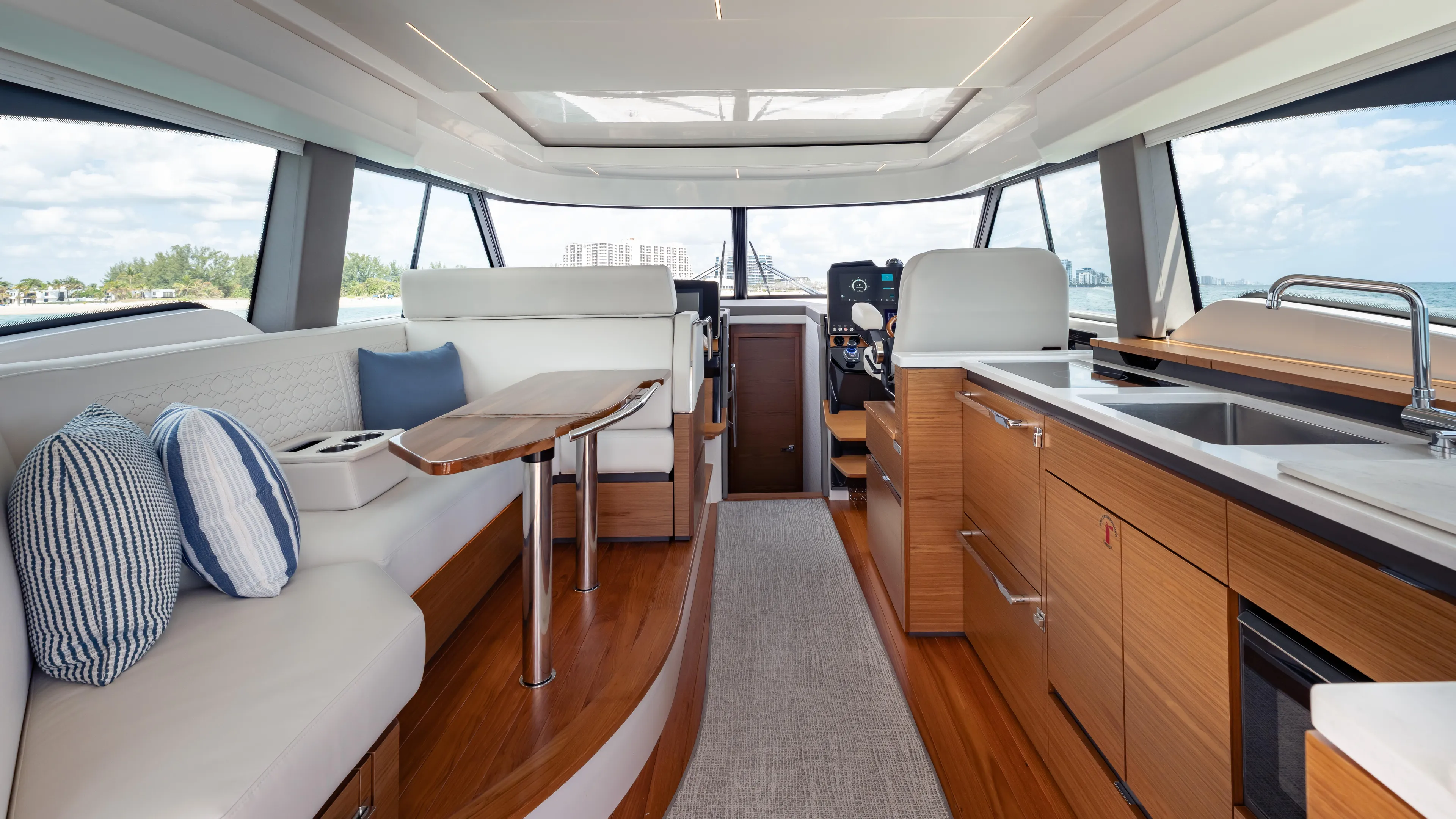  Yacht Photos Pics Luxurious interior of 2024 Tiara Yachts 48 LE, featuring modern seating and kitchen area.
