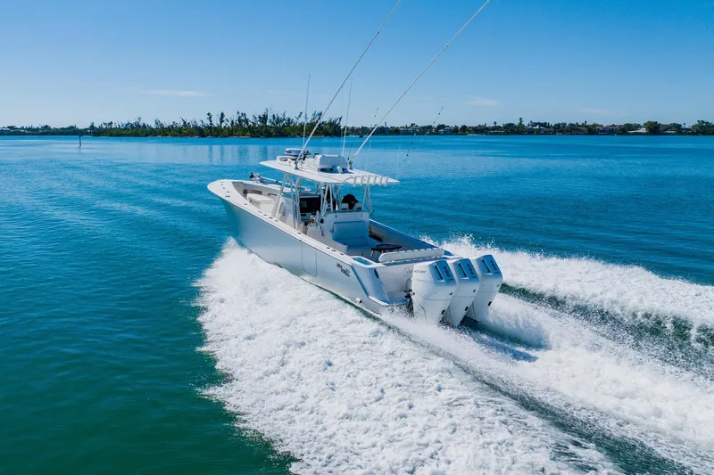  Yacht Photos Pics 2025 SeaVee 370Z boat cruising on clear blue water, showcasing triple engines.