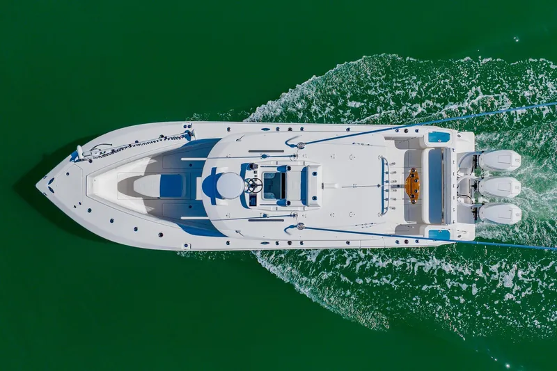  Yacht Photos Pics Aerial view of 2025 SeaVee 370Z boat cruising on green water.