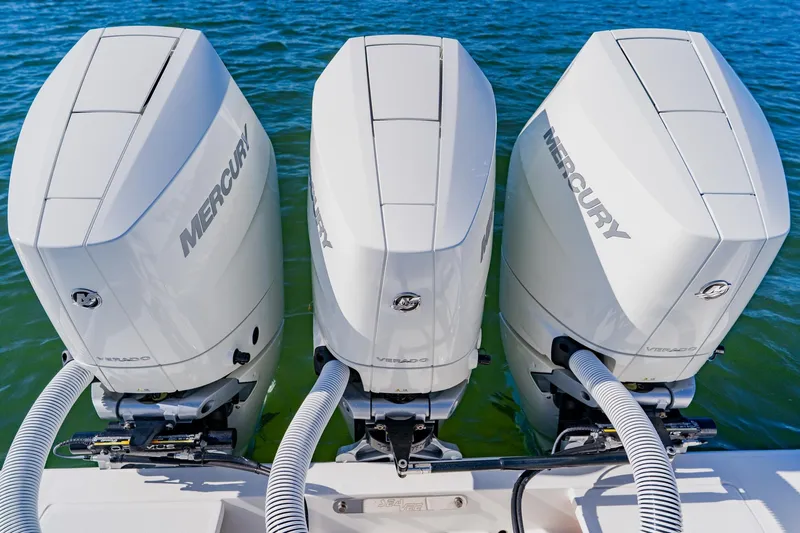  Yacht Photos Pics Triple Mercury outboard engines on a 2025 SeaVee 370Z boat, floating on clear water.