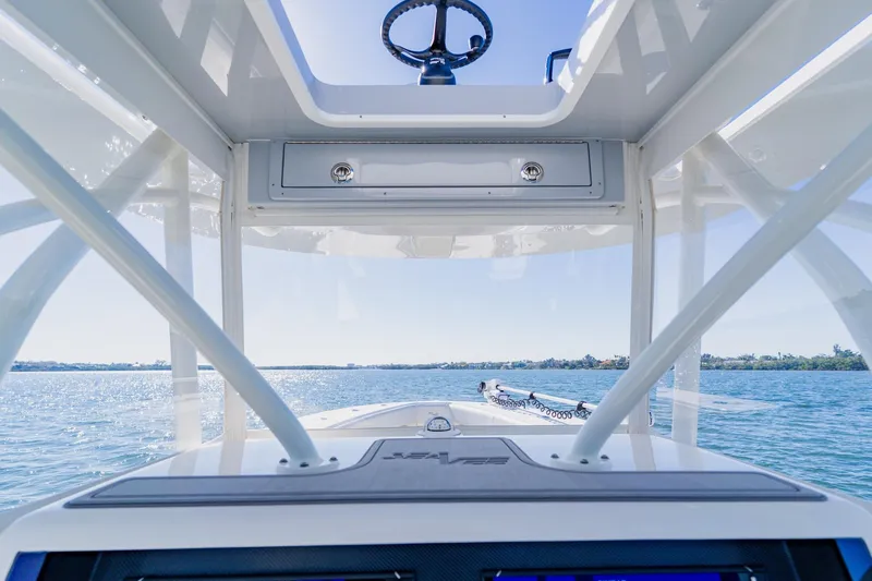  Yacht Photos Pics 2025 SeaVee 370Z boat helm view, showcasing steering and open water.