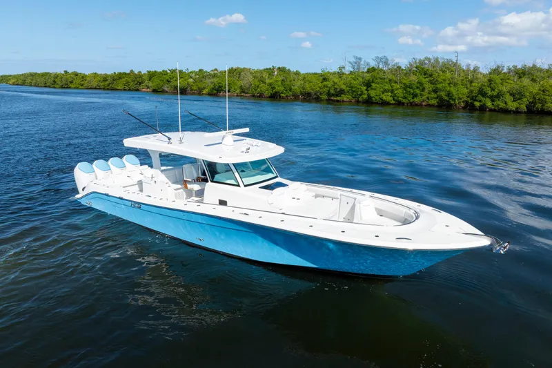  Yacht Photos Pics 2026 HCB 48 Campeon boat cruising on a serene waterway under a clear blue sky.