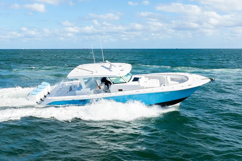  Yacht Photos Pics 2026 HCB 48 Campeon boat cruising on open ocean under clear blue sky.