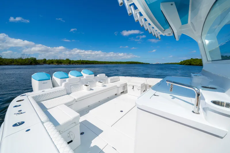  Yacht Photos Pics 2026 HCB 48 Campeon luxury boat on a serene waterway under a clear blue sky.