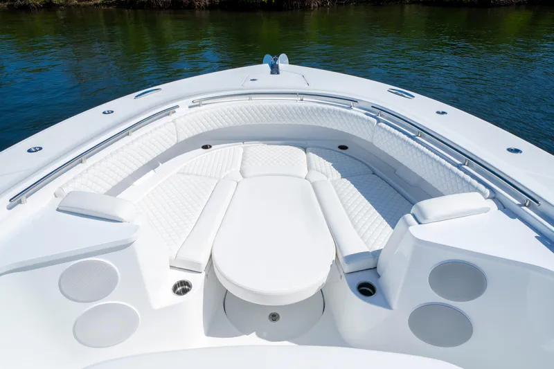  Yacht Photos Pics Luxurious seating area on 2026 HCB 48 Campeon boat, featuring white quilted upholstery.