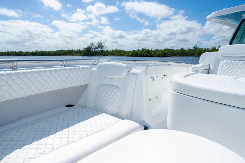  Yacht Photos Pics Luxurious seating on 2026 HCB 48 Campeon boat, with quilted white upholstery and scenic water view.