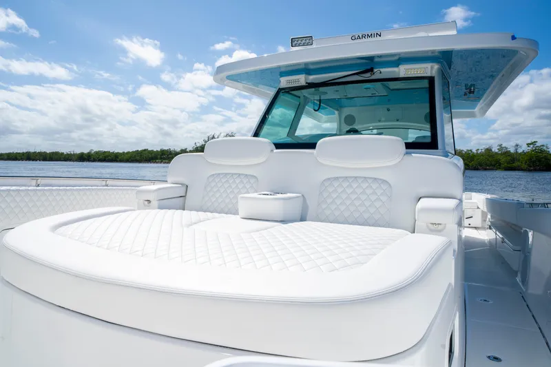  Yacht Photos Pics 2026 HCB 48 Campeon luxury boat with plush seating and Garmin equipment on a sunny day.