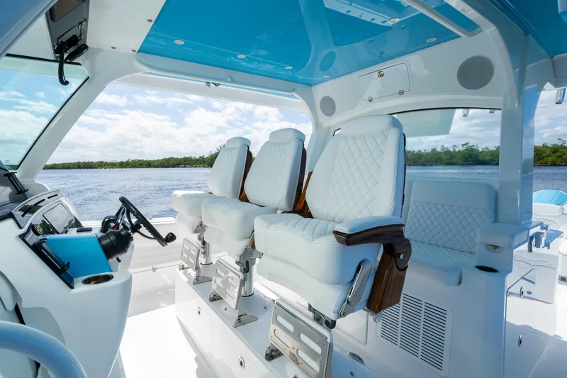  Yacht Photos Pics Luxury seating on 2026 HCB 48 Campeon boat, featuring elegant white upholstery and modern design.