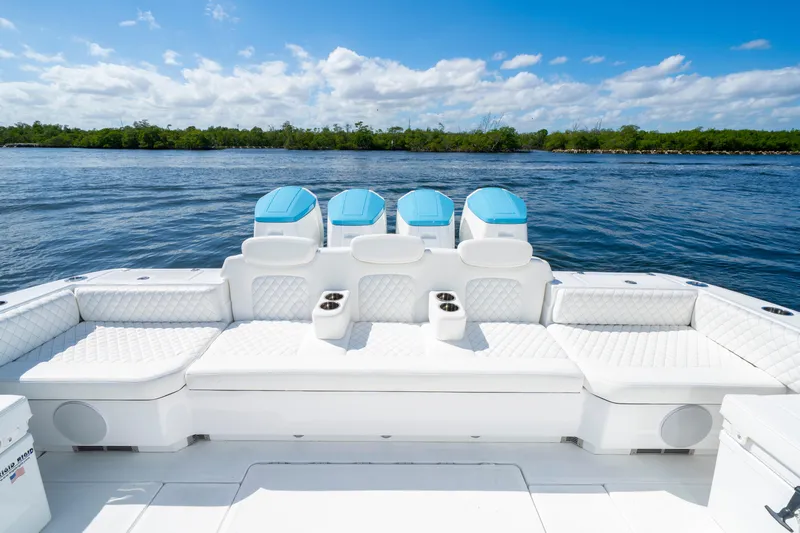  Yacht Photos Pics Luxurious 2026 HCB 48 Campeon boat with plush seating and powerful engines on a serene waterway.
