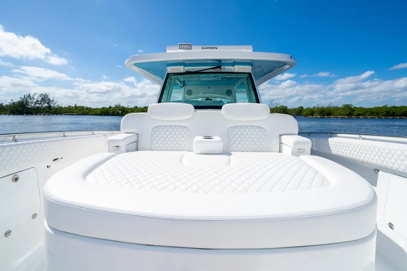  Yacht Photos Pics 2026 HCB 48 Campeon boat with luxurious white seating, on a sunny day by the water.