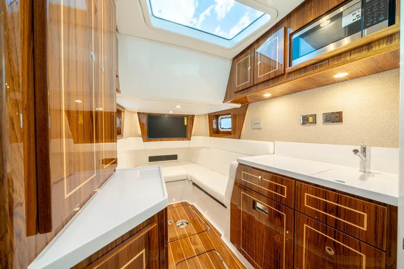  Yacht Photos Pics Luxurious interior of 2026 HCB 48 Campeon yacht with modern kitchen and seating area.