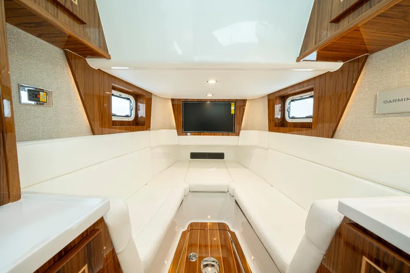  Yacht Photos Pics Luxurious interior of 2026 HCB 48 Campeon yacht with white seating and wood accents.