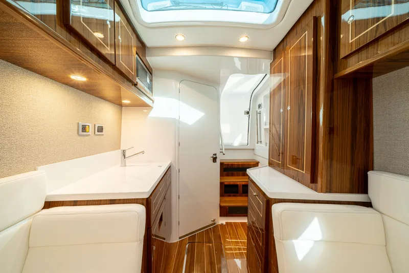  Yacht Photos Pics Luxurious interior of 2026 HCB 48 Campeon yacht with wood finishes and modern amenities.