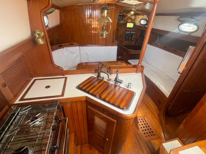 Mi Velero Yacht Photos Pics 1985 Hans Christian 33T yacht interior with wooden finishes and compact kitchen area.