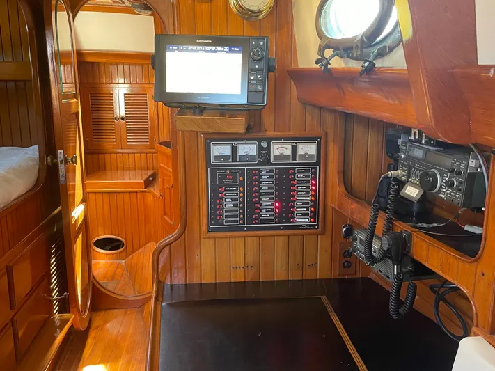 Mi Velero Yacht Photos Pics Interior of 1985 Hans Christian 33T sailboat with navigation equipment and wooden paneling.