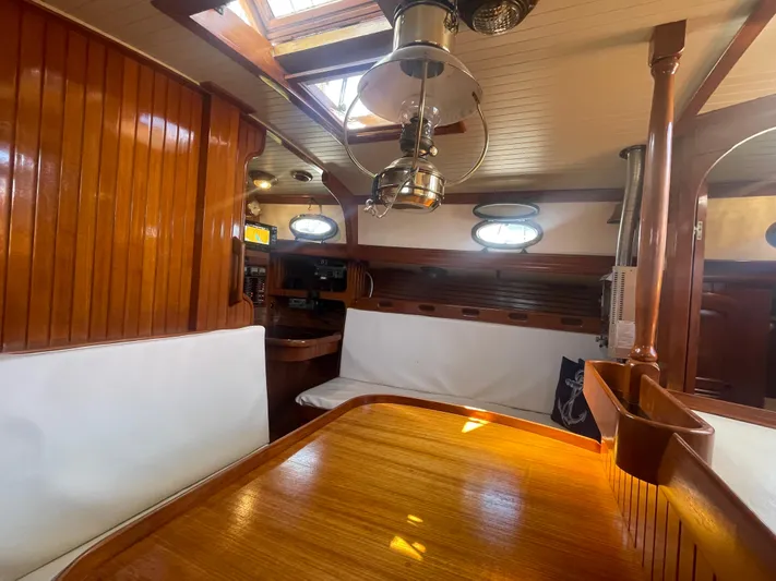 Mi Velero Yacht Photos Pics Interior of 1985 Hans Christian 33T sailboat with wooden finishes and cozy seating area.