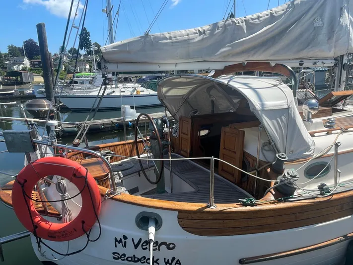 Mi Velero Yacht Photos Pics 1985 Hans Christian 33T sailboat docked, featuring wooden deck and lifebuoy, Seabeck WA.