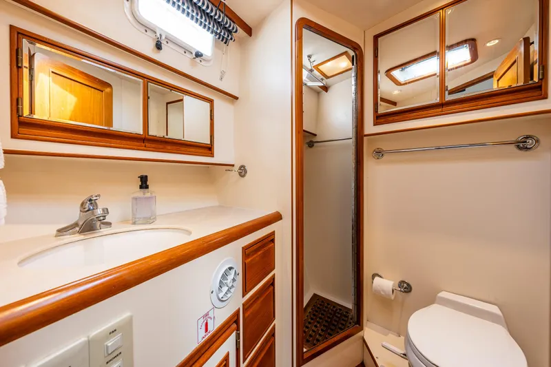 Am&eacute;lie Yacht Photos Pics Bathroom interior of 1997 Offshore Yachts 52 Sedan, featuring sink, mirror, and shower.
