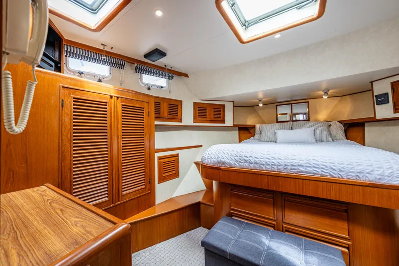 Am&eacute;lie Yacht Photos Pics Luxurious cabin interior of 1997 Offshore Yachts 52 Sedan with wood finishes and skylights.