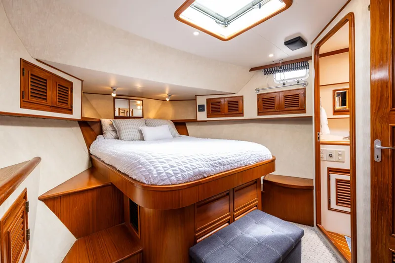 Am&eacute;lie Yacht Photos Pics Luxurious cabin interior of 1997 Offshore Yachts 52 Sedan with cozy bed and wooden accents.