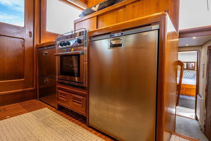 Am&eacute;lie Yacht Photos Pics Interior of 1997 Offshore Yachts 52 Sedan, featuring modern kitchen appliances and wood cabinetry.