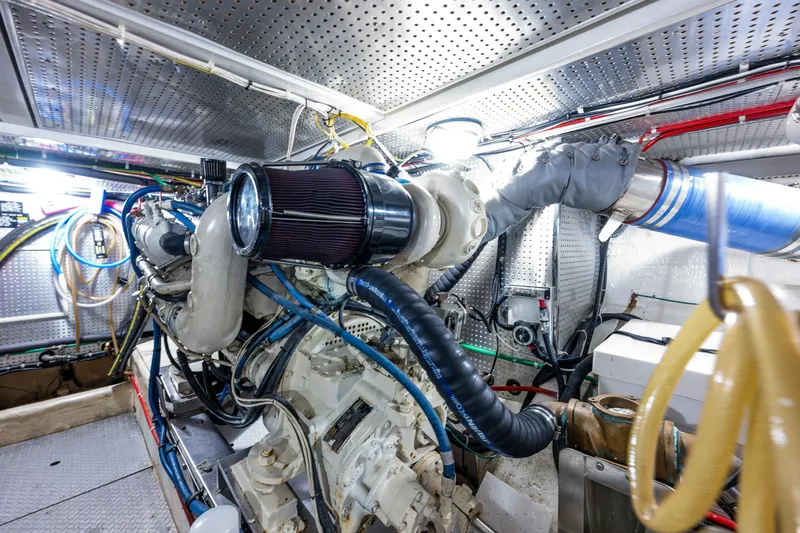 Am&eacute;lie Yacht Photos Pics Engine room of a 1997 Offshore Yachts 52 Sedan, showcasing complex machinery and wiring.