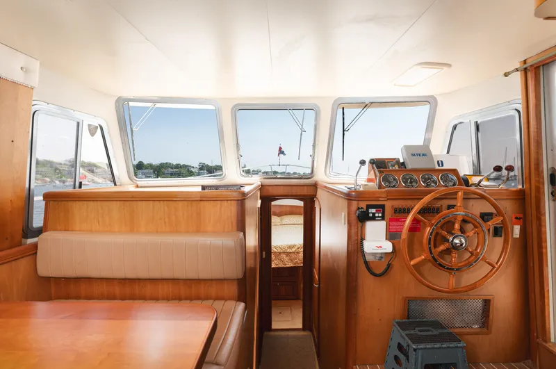  Yacht Photos Pics 2005 Mainship 400 Trawler interior with helm, wooden accents, and seating area.