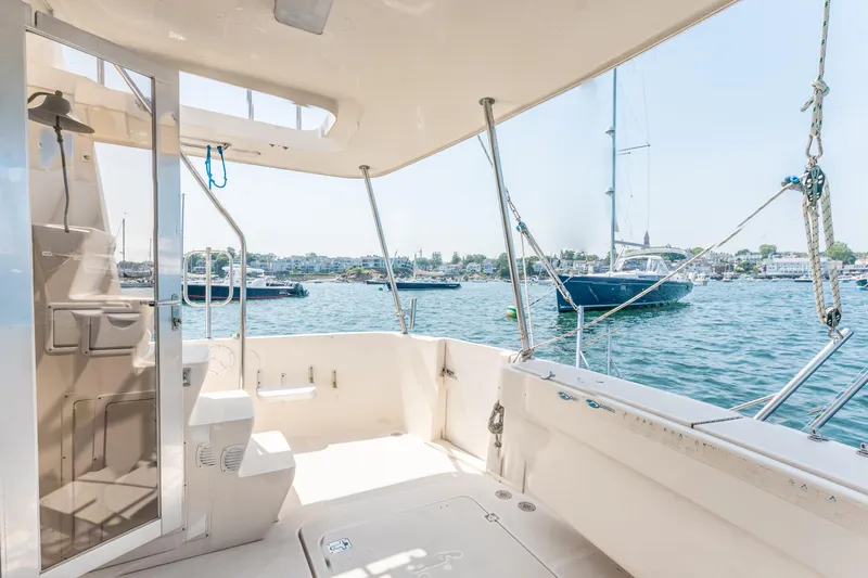  Yacht Photos Pics 2005 Mainship 400 Trawler deck with marina view, featuring spacious seating and clear skies.