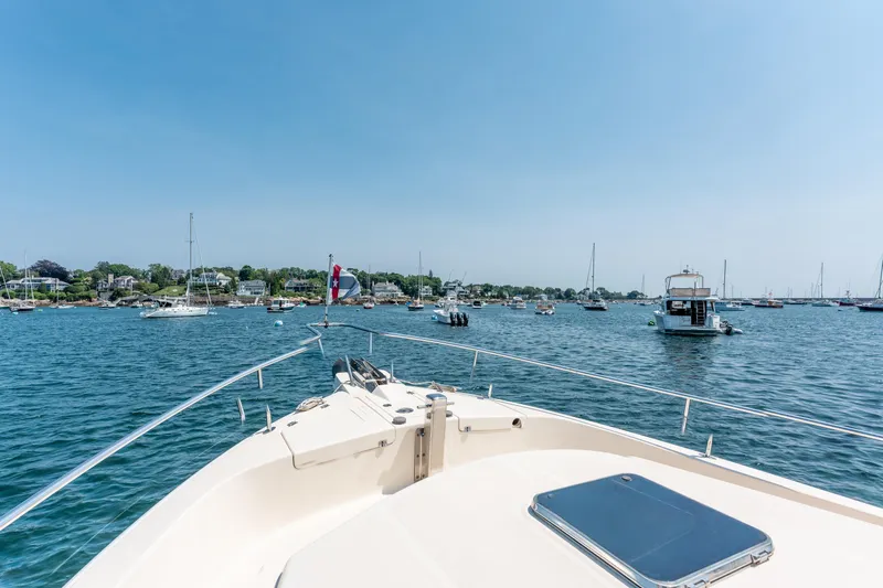  Yacht Photos Pics Bow view from 2005 Mainship 400 Trawler in a scenic harbor with sailboats.