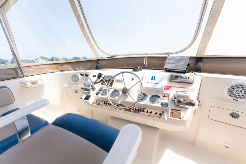  Yacht Photos Pics Helm of 2005 Mainship 400 Trawler with navigation equipment and steering wheel.