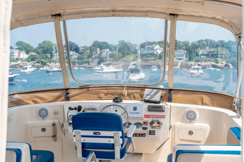  Yacht Photos Pics 2005 Mainship 400 Trawler helm with scenic waterfront view and modern navigation equipment.