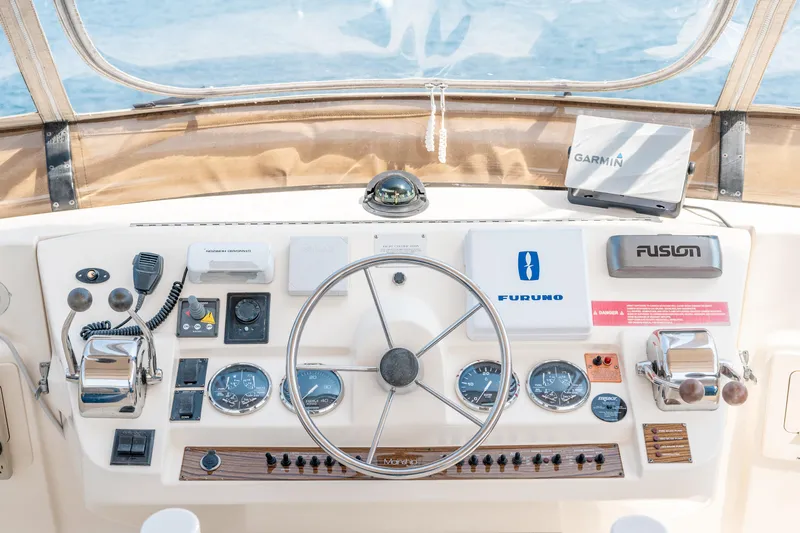  Yacht Photos Pics 2005 Mainship 400 Trawler helm with steering wheel, navigation instruments, and control panel.