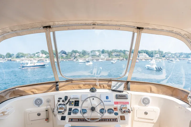  Yacht Photos Pics 2005 Mainship 400 Trawler helm with scenic harbor view and boats.